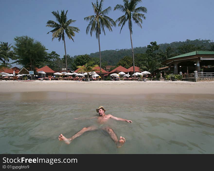 Thailand, KoChang,a man swimming in an ocean. Thailand, KoChang,a man swimming in an ocean