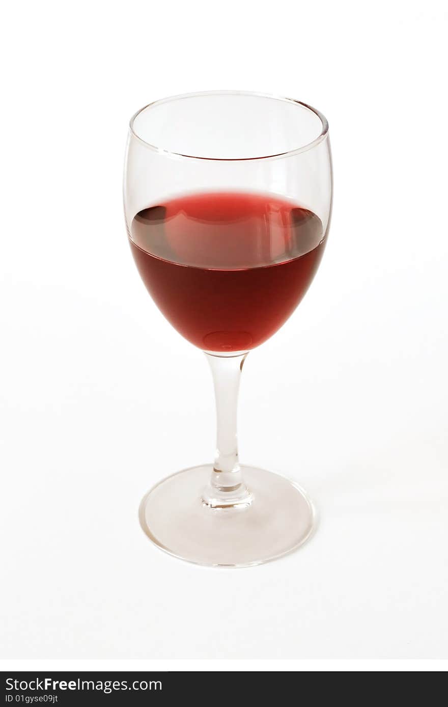 Red semisweet wine in a crystal glass on a white background. Red semisweet wine in a crystal glass on a white background