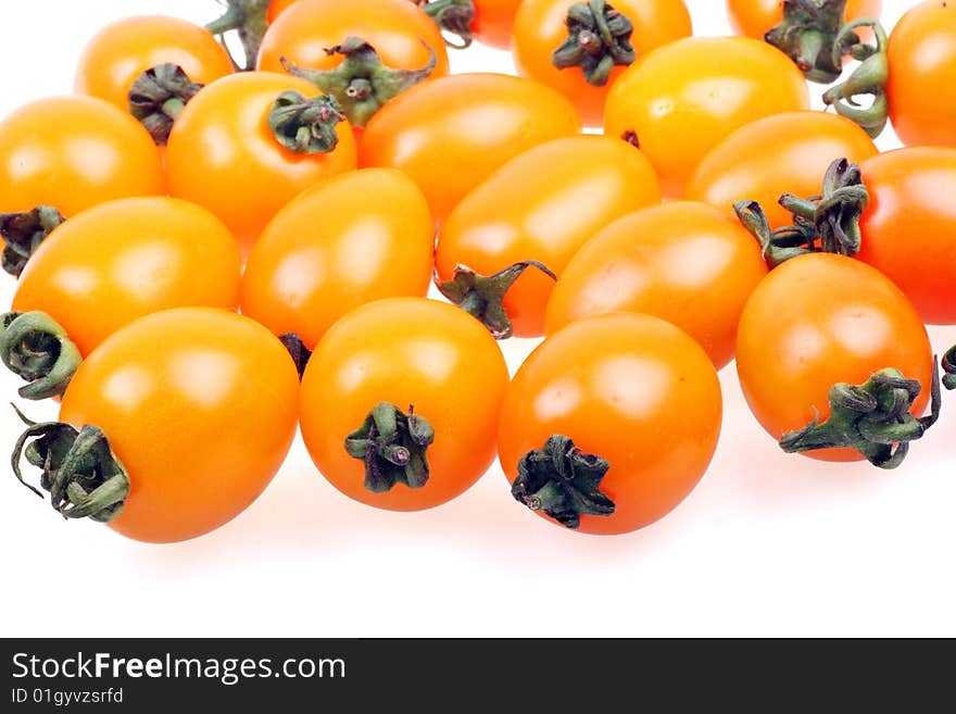 Some fresh yellow tomato on white background. Some fresh yellow tomato on white background.