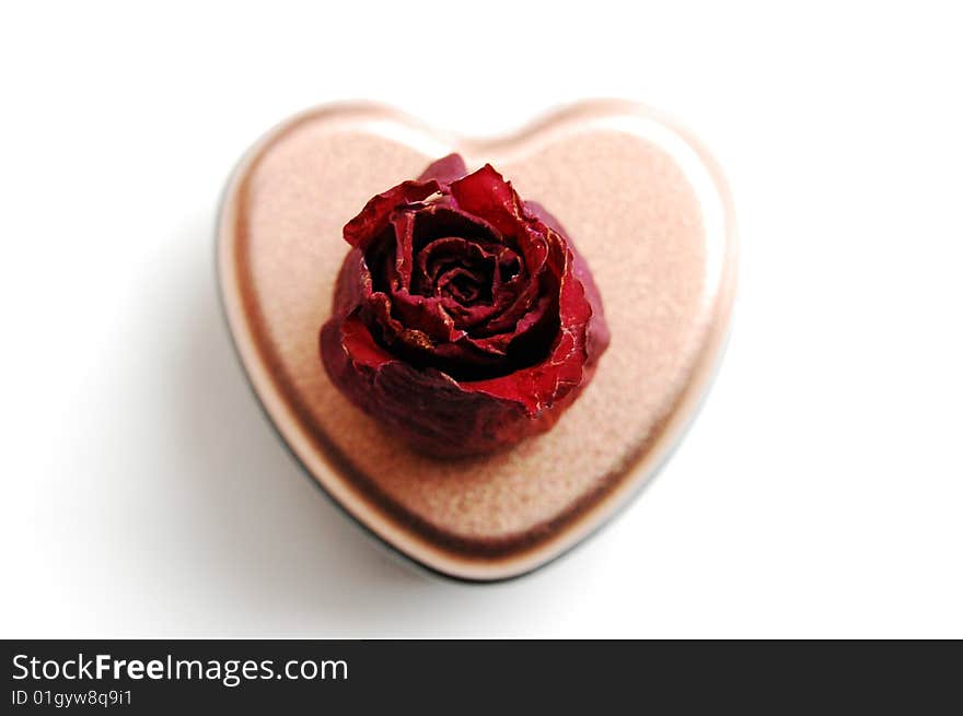 Heart-shaped box and a dried roses as a symbol of eternal, neverending love. It might also be a symbol of lost love. Depends on the slogan. Heart-shaped box and a dried roses as a symbol of eternal, neverending love. It might also be a symbol of lost love. Depends on the slogan.