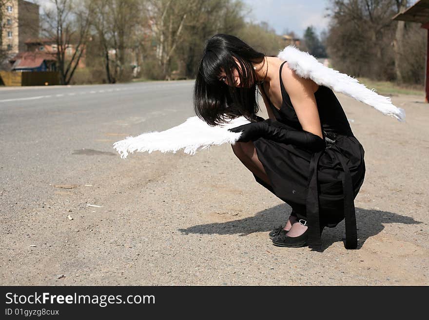 Sad angel with broken wing outdoors. Sad angel with broken wing outdoors