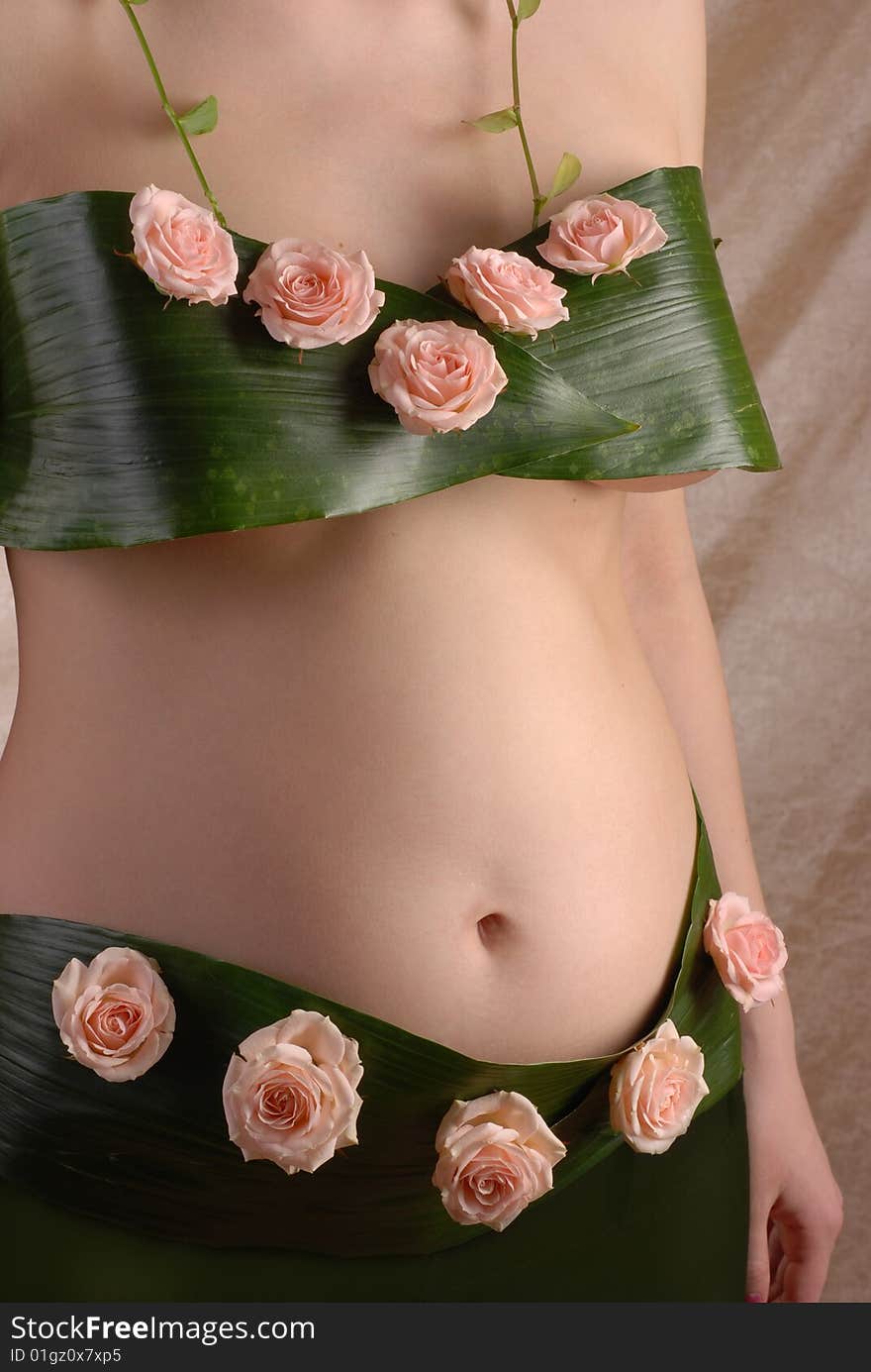 Pregnancy woman in the dressing made of a flowers. Pregnancy woman in the dressing made of a flowers