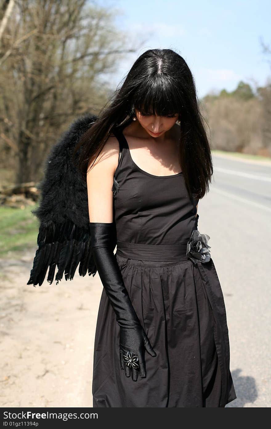 Sad black angel at road. Sad black angel at road