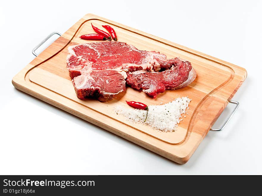 Raw beef cut kown as striploin or T-Bone steak. Raw beef cut kown as striploin or T-Bone steak.