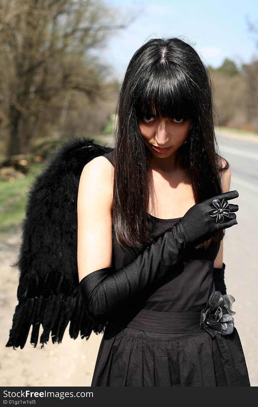 Black angel outdoors at road