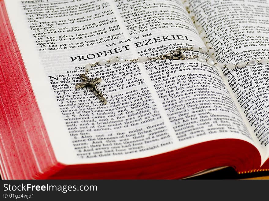 Close up of Ezekiel bible page with rosary. Close up of Ezekiel bible page with rosary