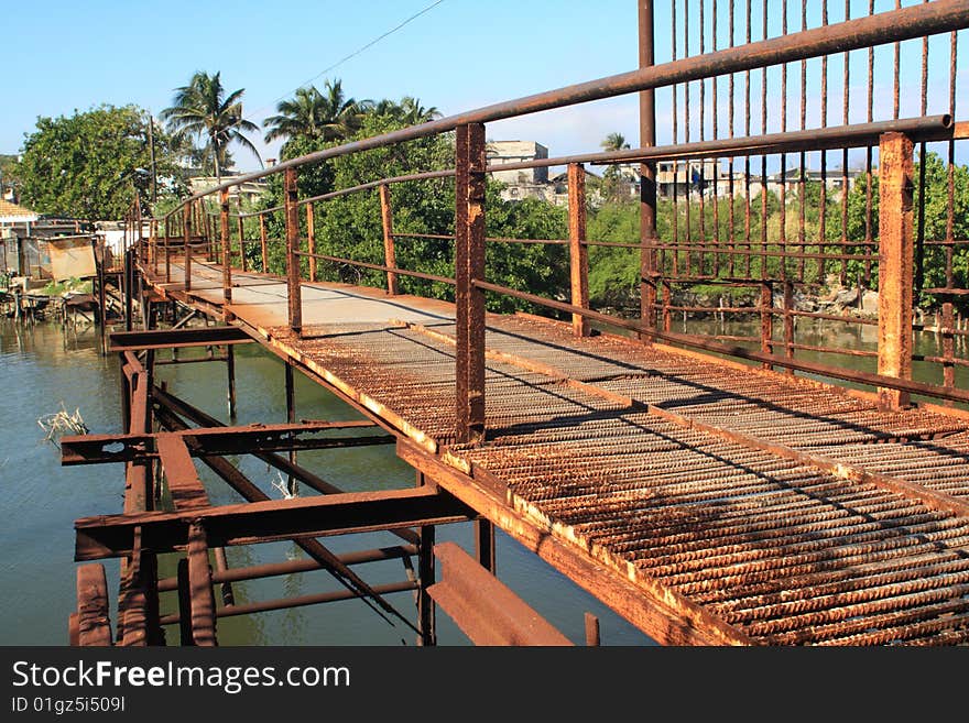 Old Rusty Iron Bridge Over A River