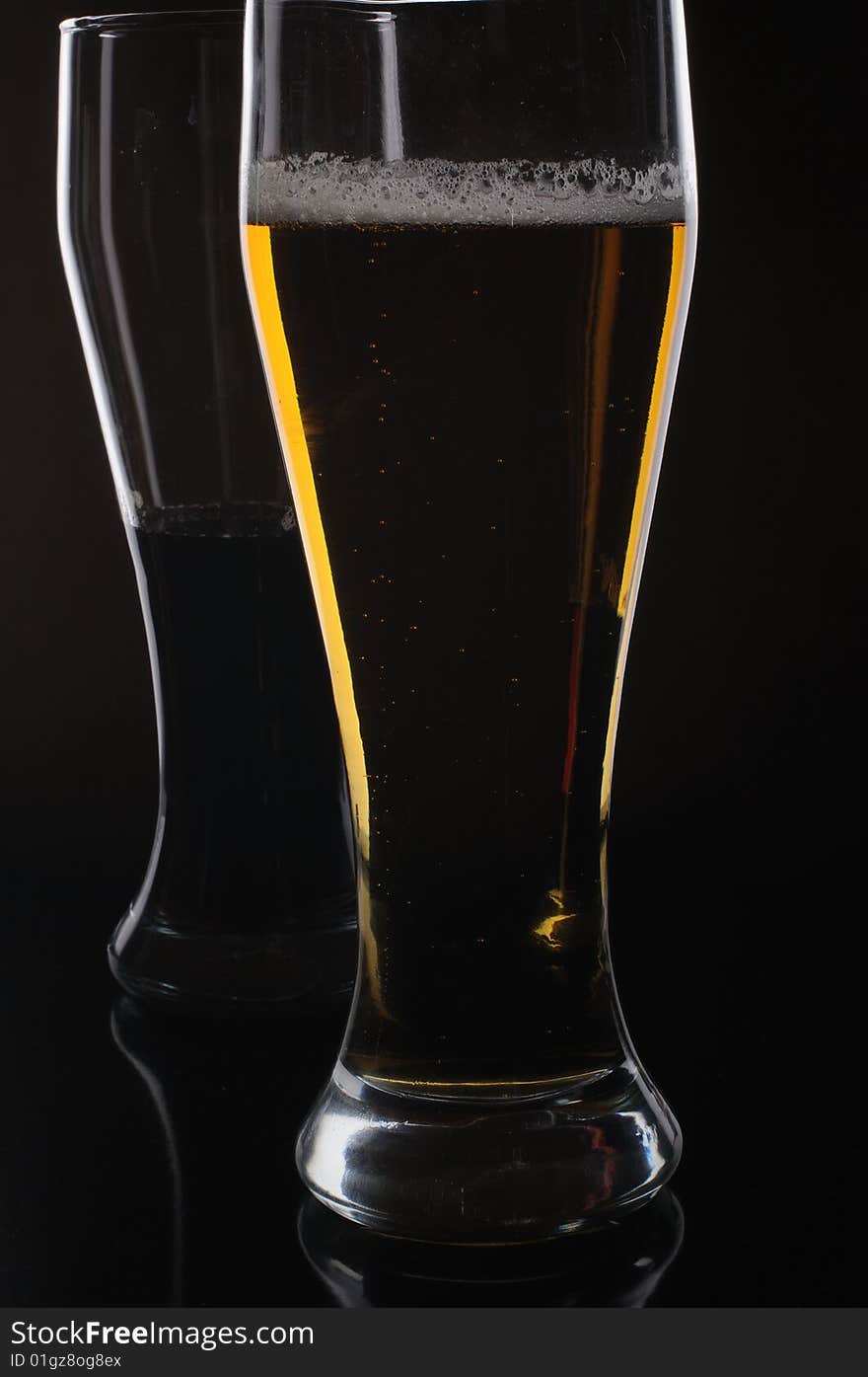 Three glasses with light and dark beer. Three glasses with light and dark beer