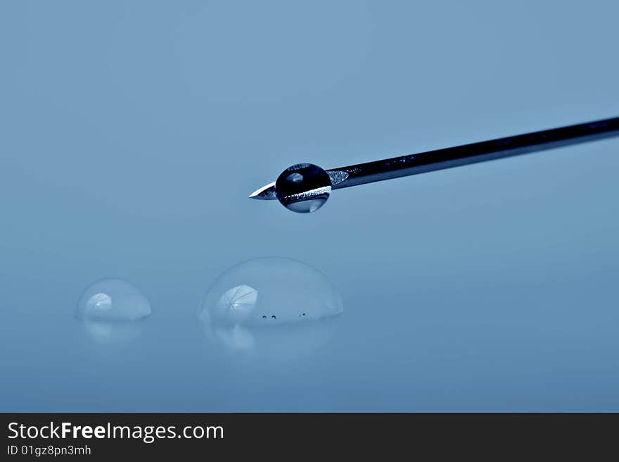 Sharp syringe needle with drops ,macro