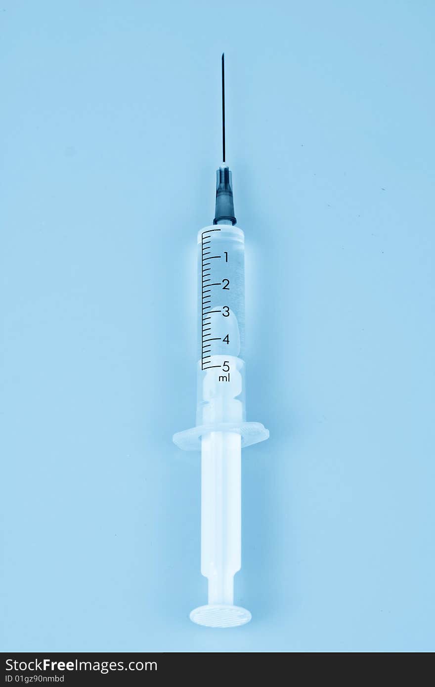 Photo of syringe in blue tones