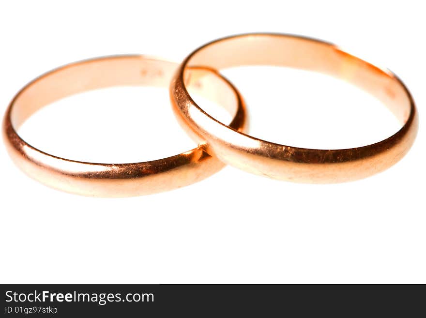 Pair of golden wedding rings isolated on white