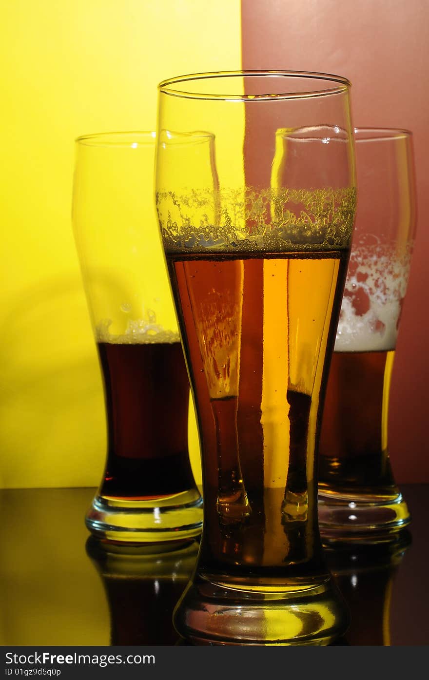 Three glasses with light and dark beer. Three glasses with light and dark beer