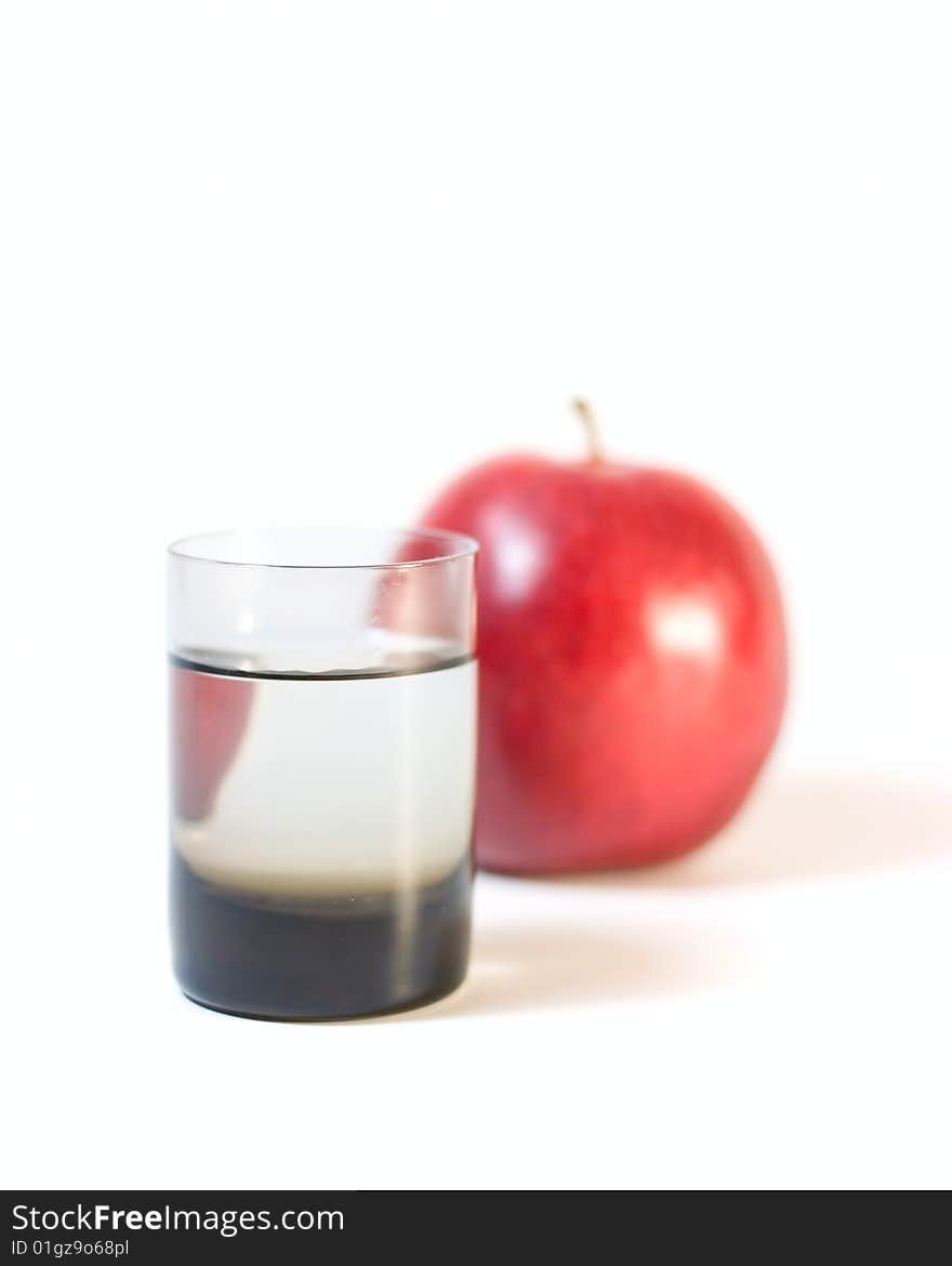 Glass with water and apple isolated on white