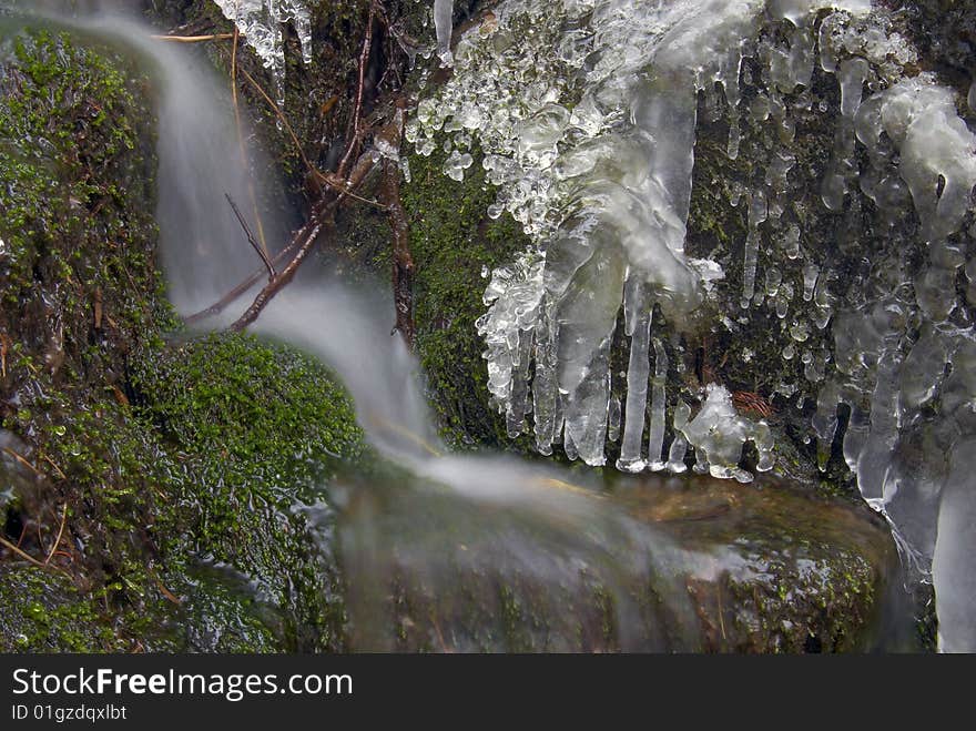 Frozen creek and icicles