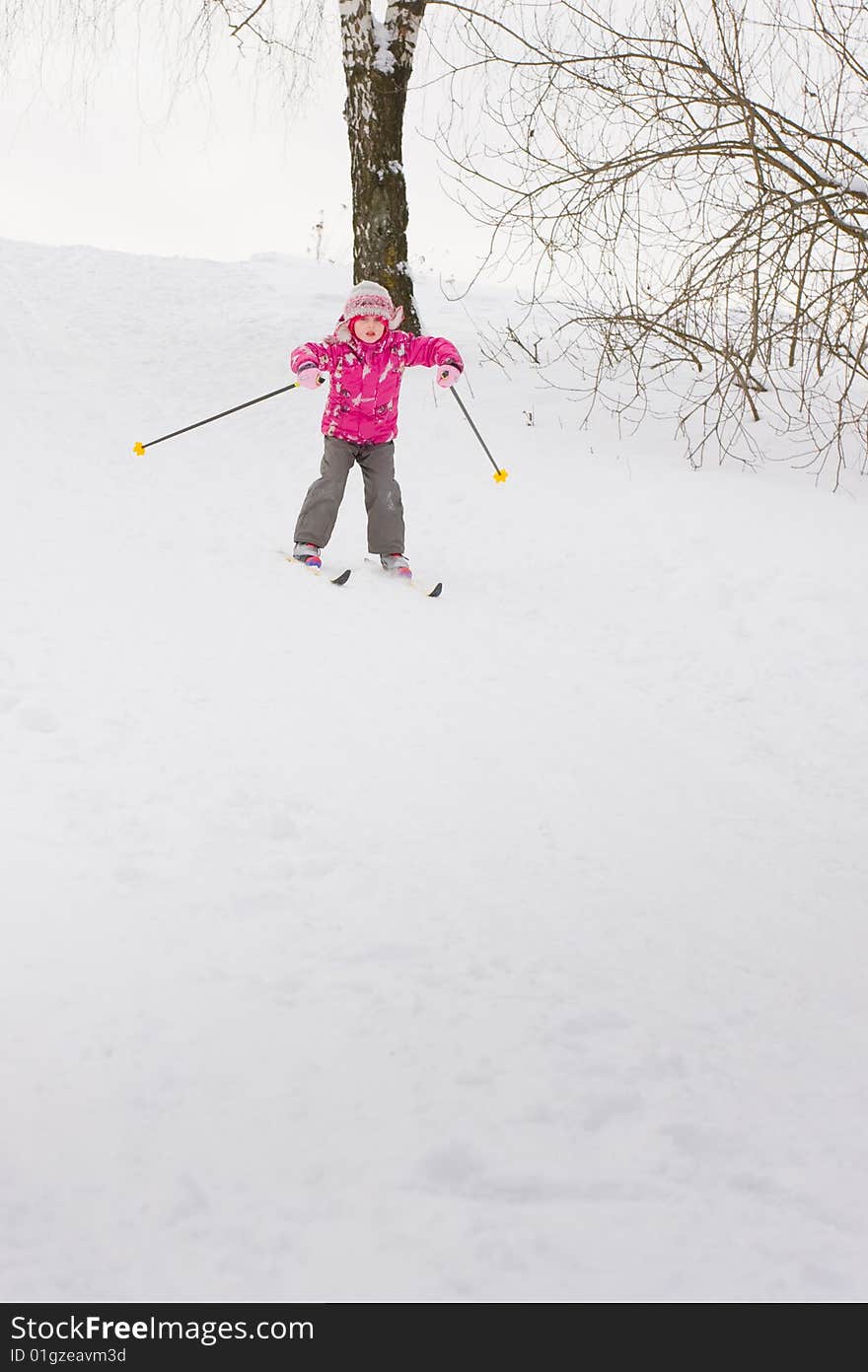 5 year old girl cross-country skiing, sliding down hill. 5 year old girl cross-country skiing, sliding down hill