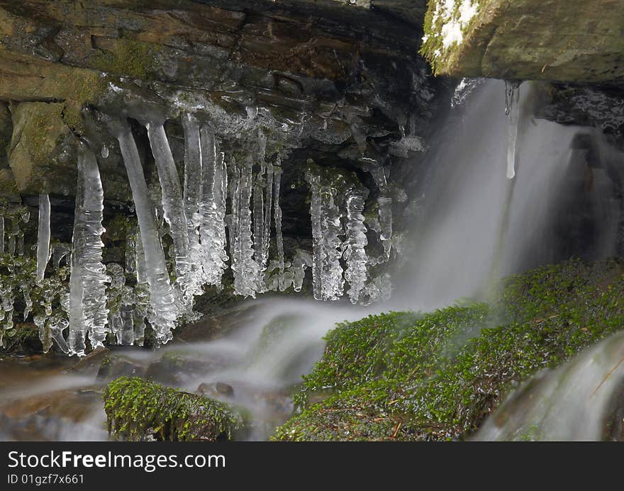 Frozen creek and icicles