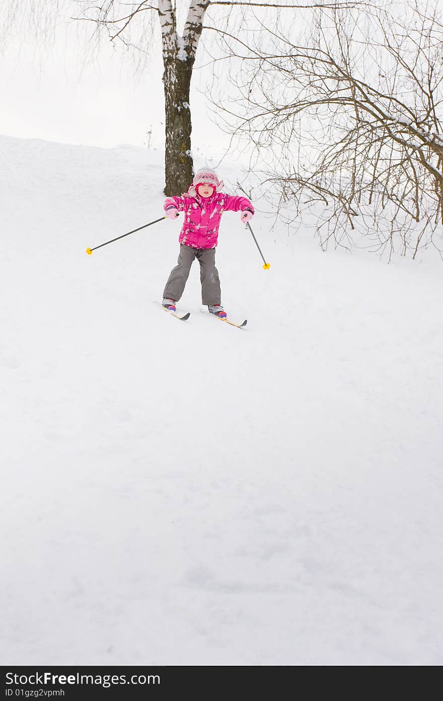 5 year old girl cross-country skiing, sliding down hill. 5 year old girl cross-country skiing, sliding down hill