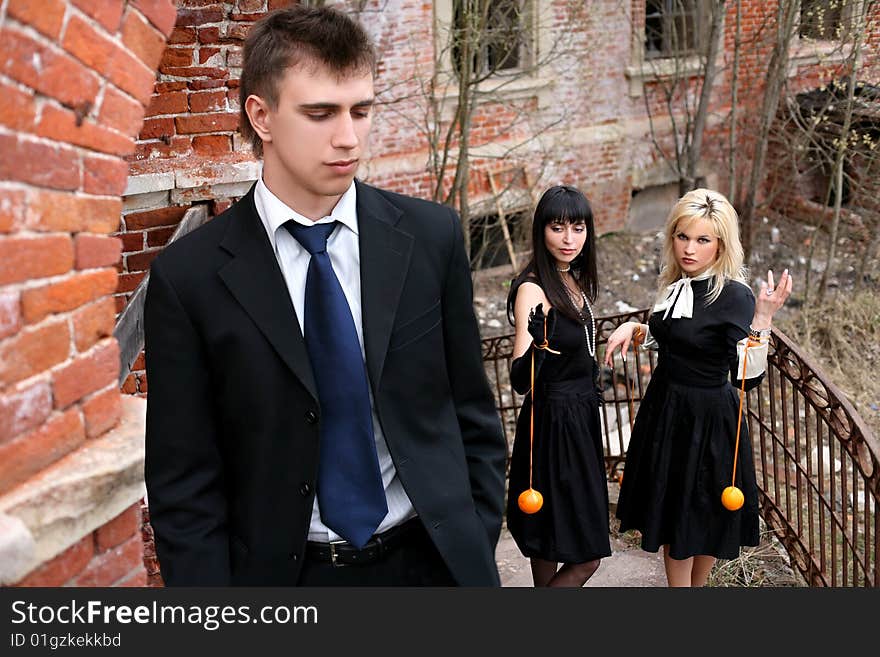 Two girl with oranges and man beside old house. Two girl with oranges and man beside old house