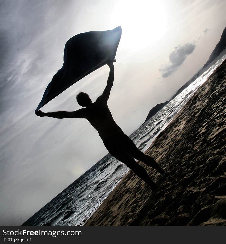 Man standing on the beach in sunset. Man standing on the beach in sunset