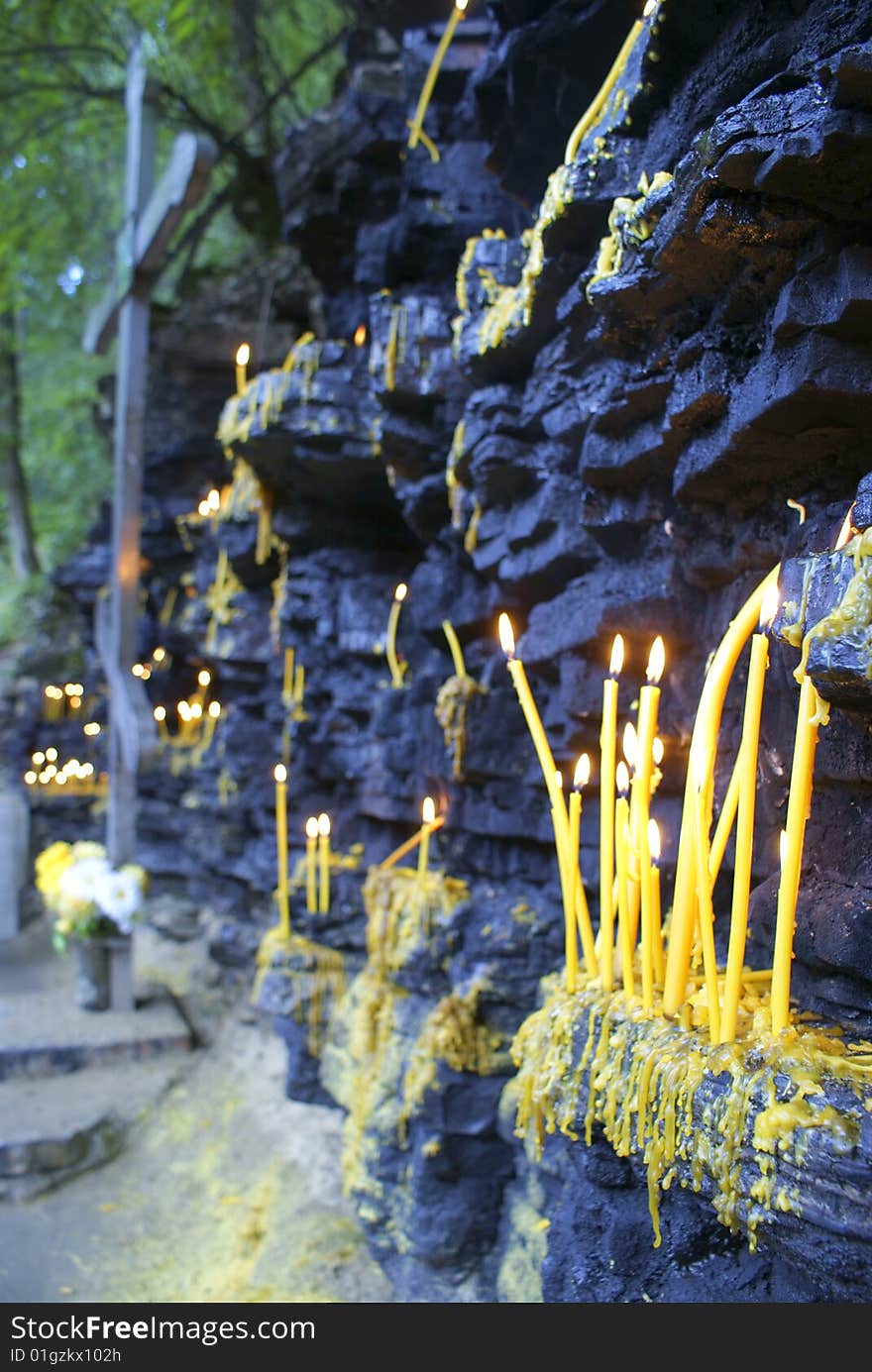 Burning candles stand on grief