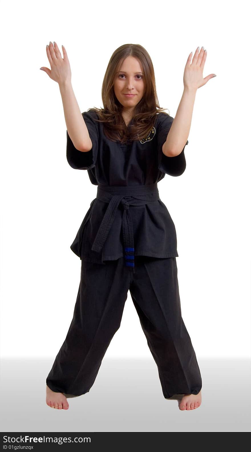 Young girl in a black kimono with the emblem of Kung Fu. Young girl in a black kimono with the emblem of Kung Fu