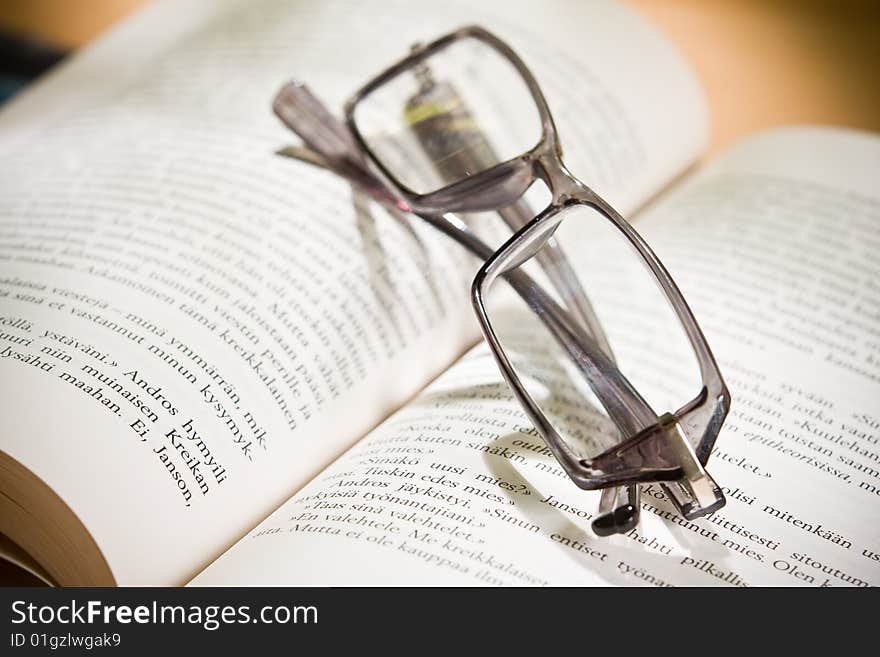 Closeup of opened book and glasses