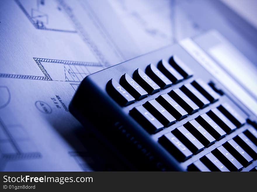 Calculator and house plan blueprints close up