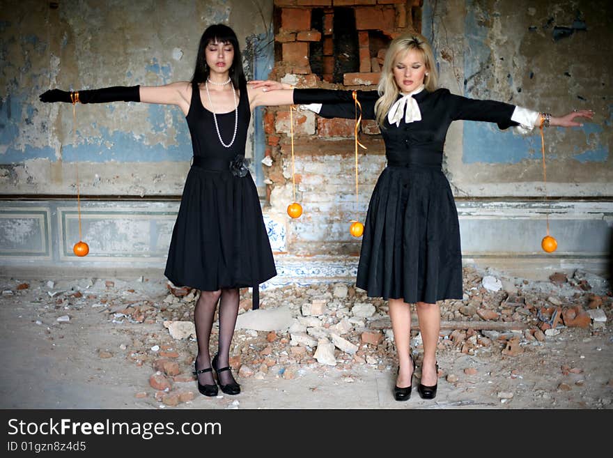 Two girl with oranges  inside vintage house. Two girl with oranges  inside vintage house