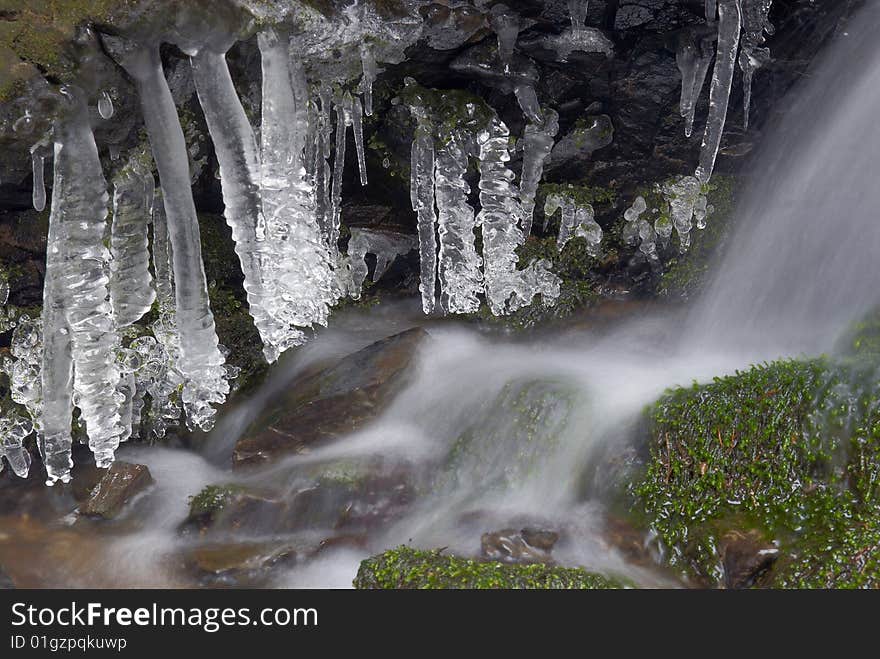 Frozen creek and icicles