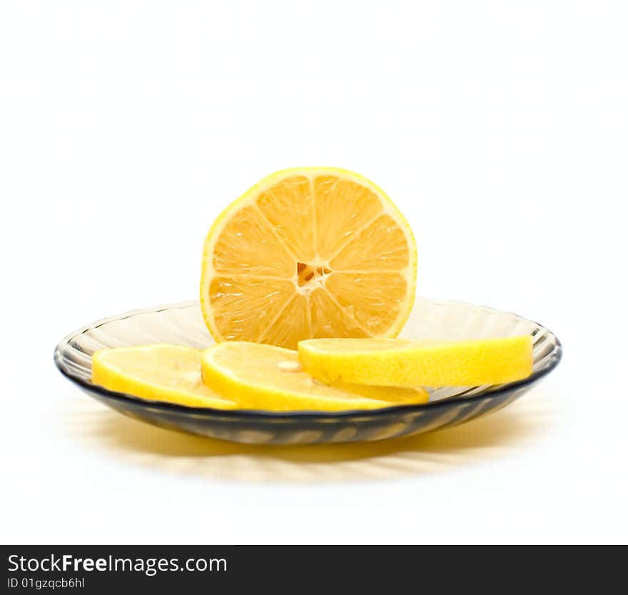 Lemon slices on plate isolated on white