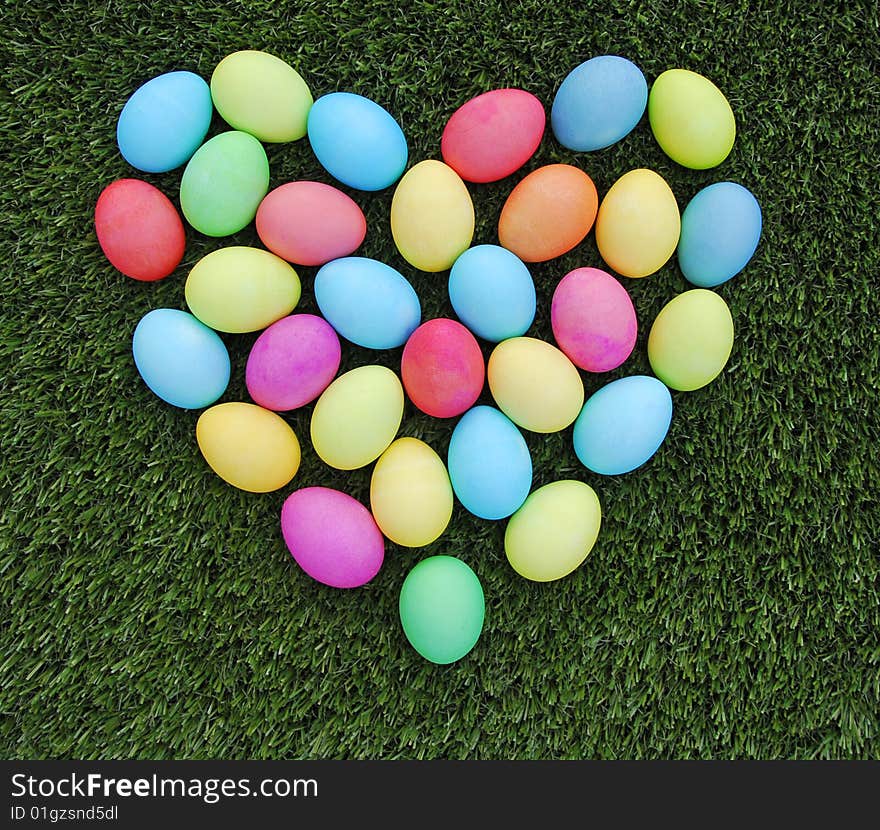 Colorful easter egg heartarrow on the green grass. Colorful easter egg heartarrow on the green grass