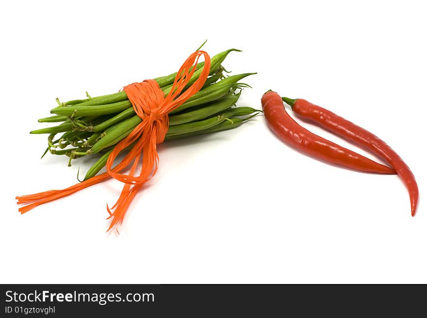 Green pods tied up orange ribbon, chilli. Green pods tied up orange ribbon, chilli