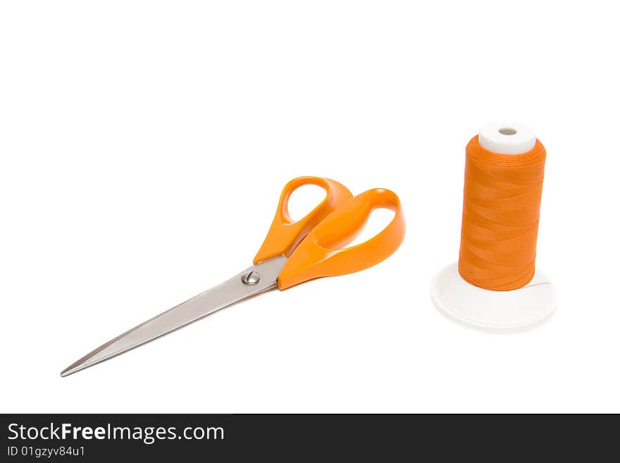 Shears and yarn on white background