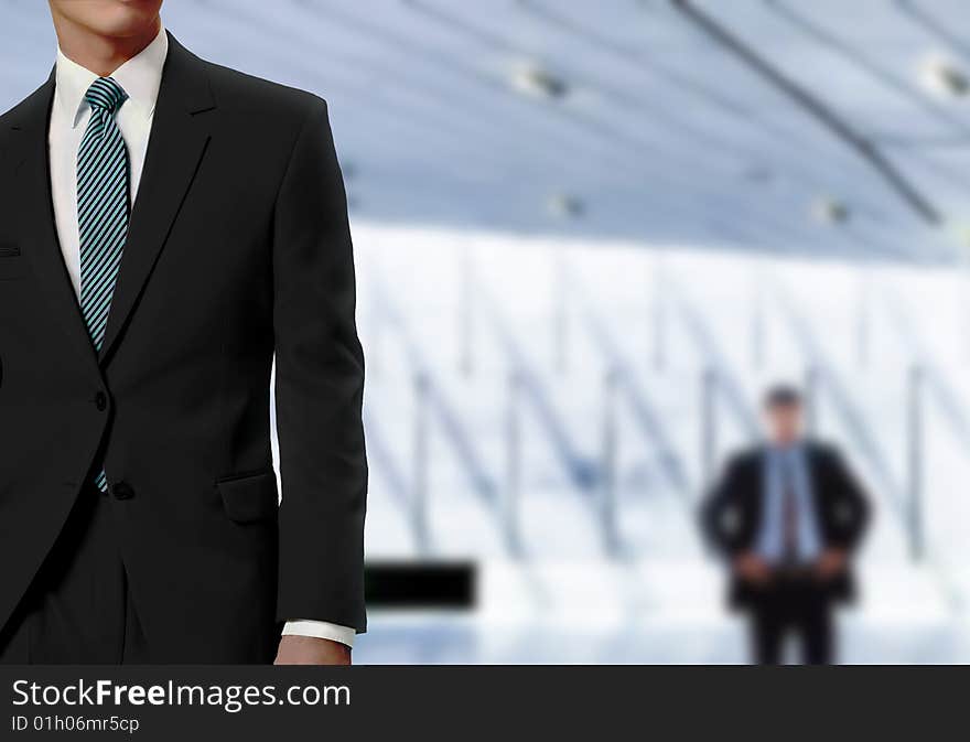 Businessman with modern office in background. Businessman with modern office in background