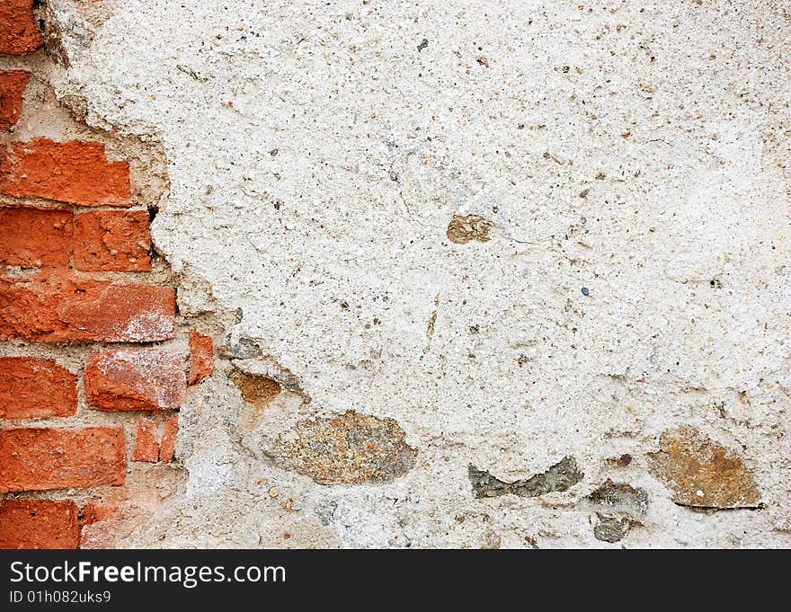 Fragment of tumbledown plastered brick wall. Fragment of tumbledown plastered brick wall