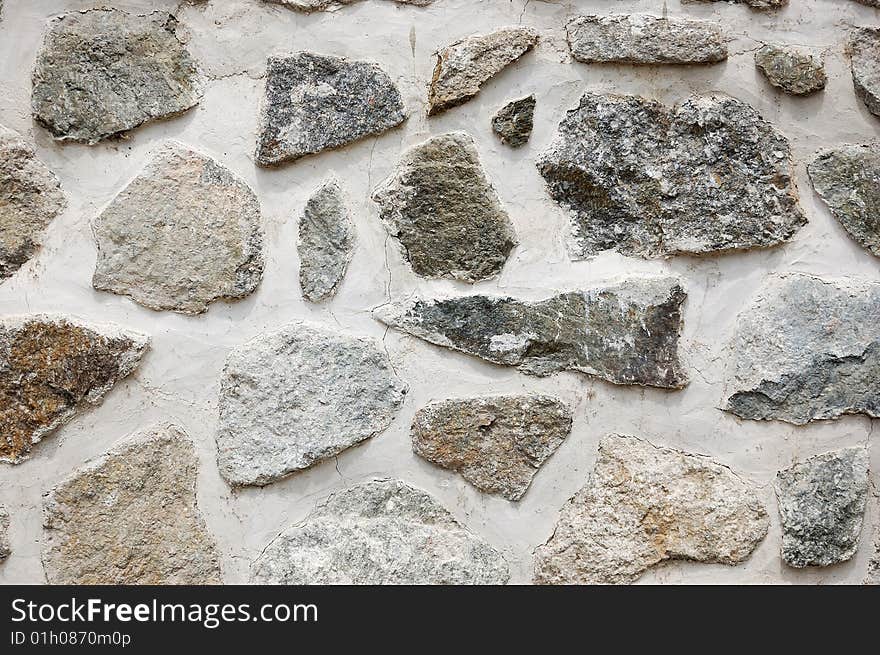 Fragment of rough wall made of irregular stones. Fragment of rough wall made of irregular stones