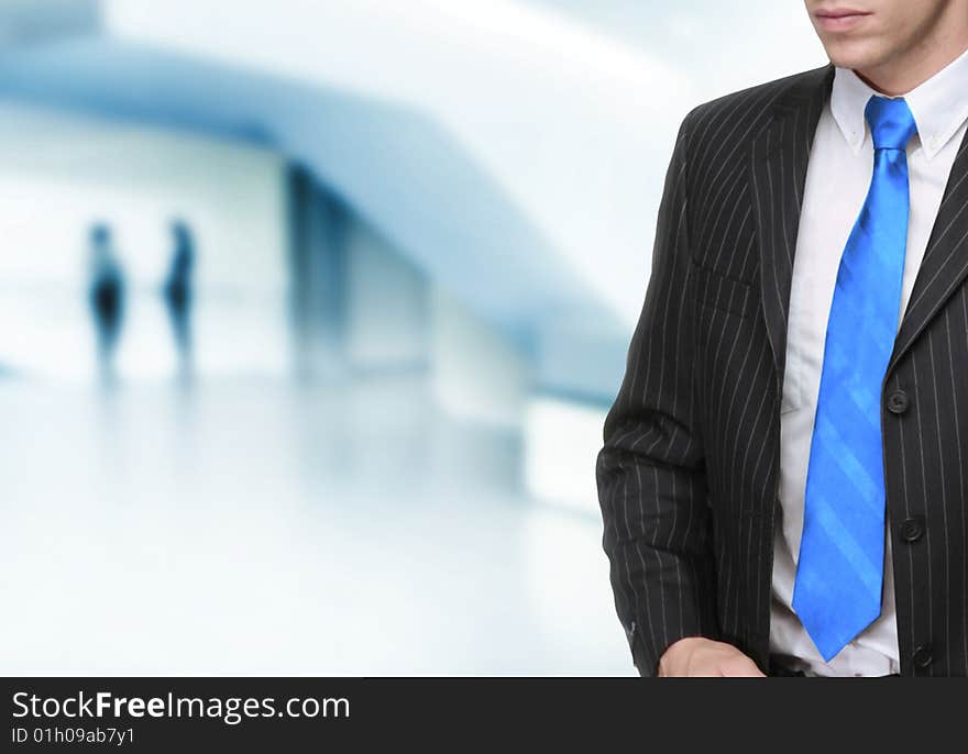 Businessman with modern office in background. Businessman with modern office in background