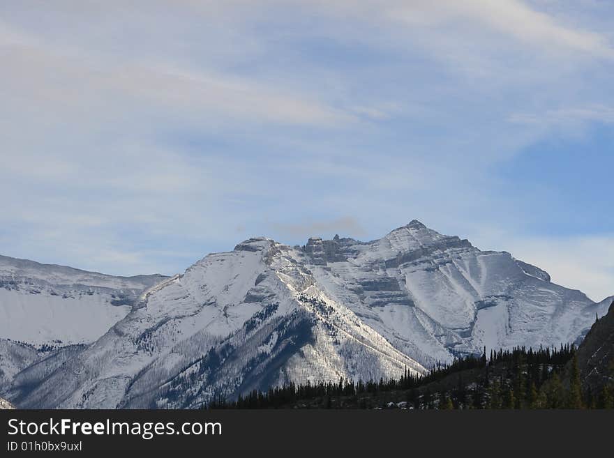 Canadian rocky mountains in winter time, snow covers the mountain range. Canadian rocky mountains in winter time, snow covers the mountain range