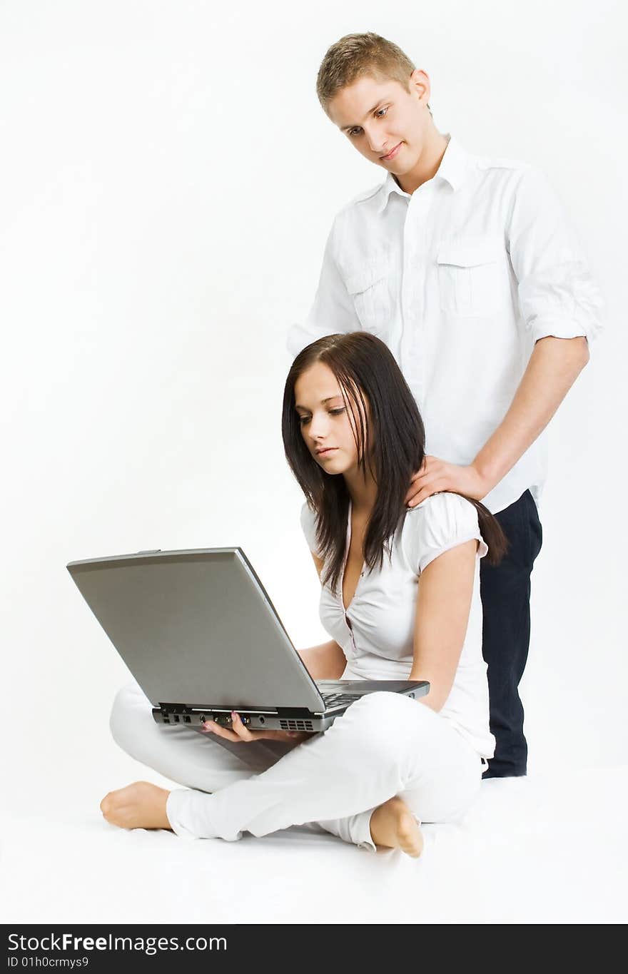 man holding hands on the shoulders of women, is behind her back, she is dissatisfied. man holding hands on the shoulders of women, is behind her back, she is dissatisfied