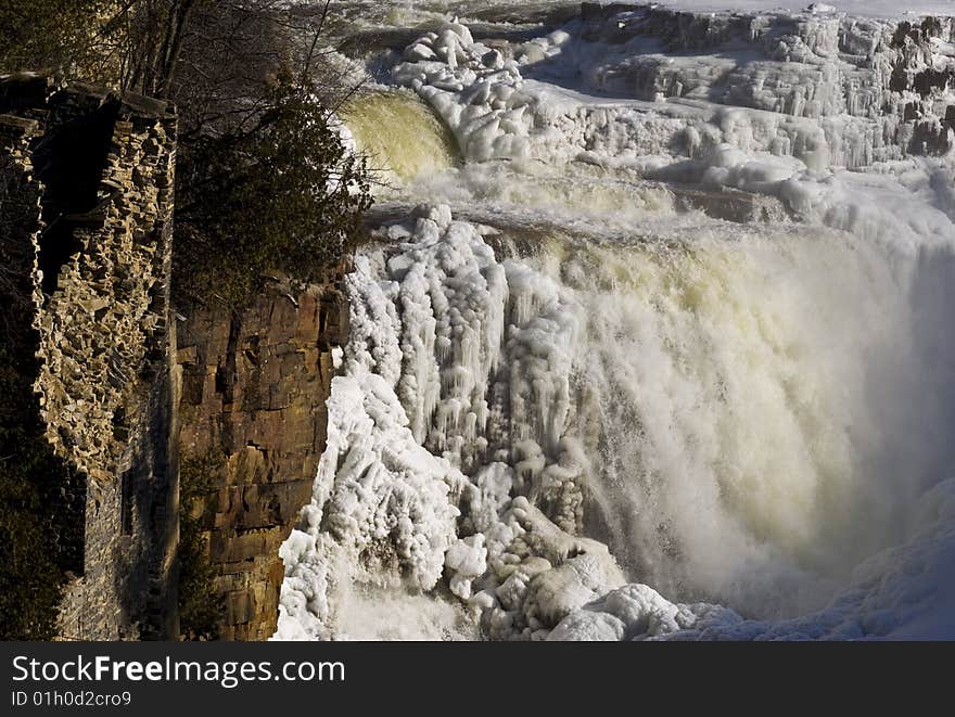 Waterfall in the winter in Ausable Chasm, upstate New York. Including the partially destroyed structure of an old building. Waterfall in the winter in Ausable Chasm, upstate New York. Including the partially destroyed structure of an old building