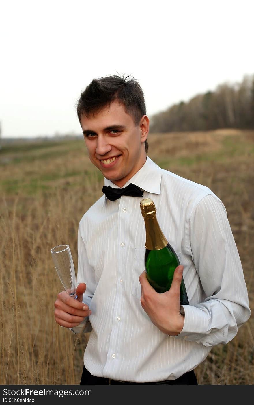 Young man with a glass and bottle of wine. Young man with a glass and bottle of wine