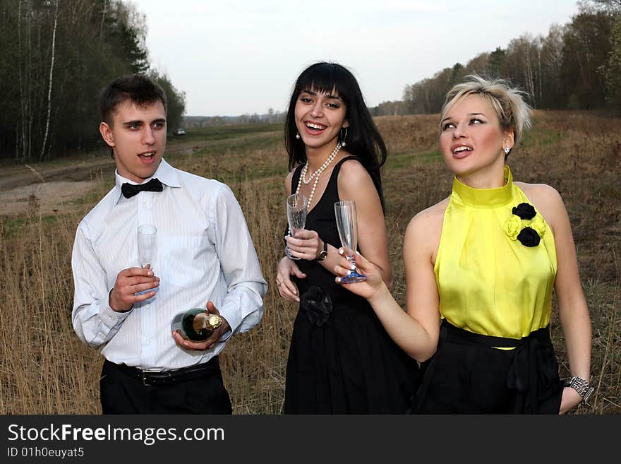 Two girl and man with wine outdoors. Two girl and man with wine outdoors