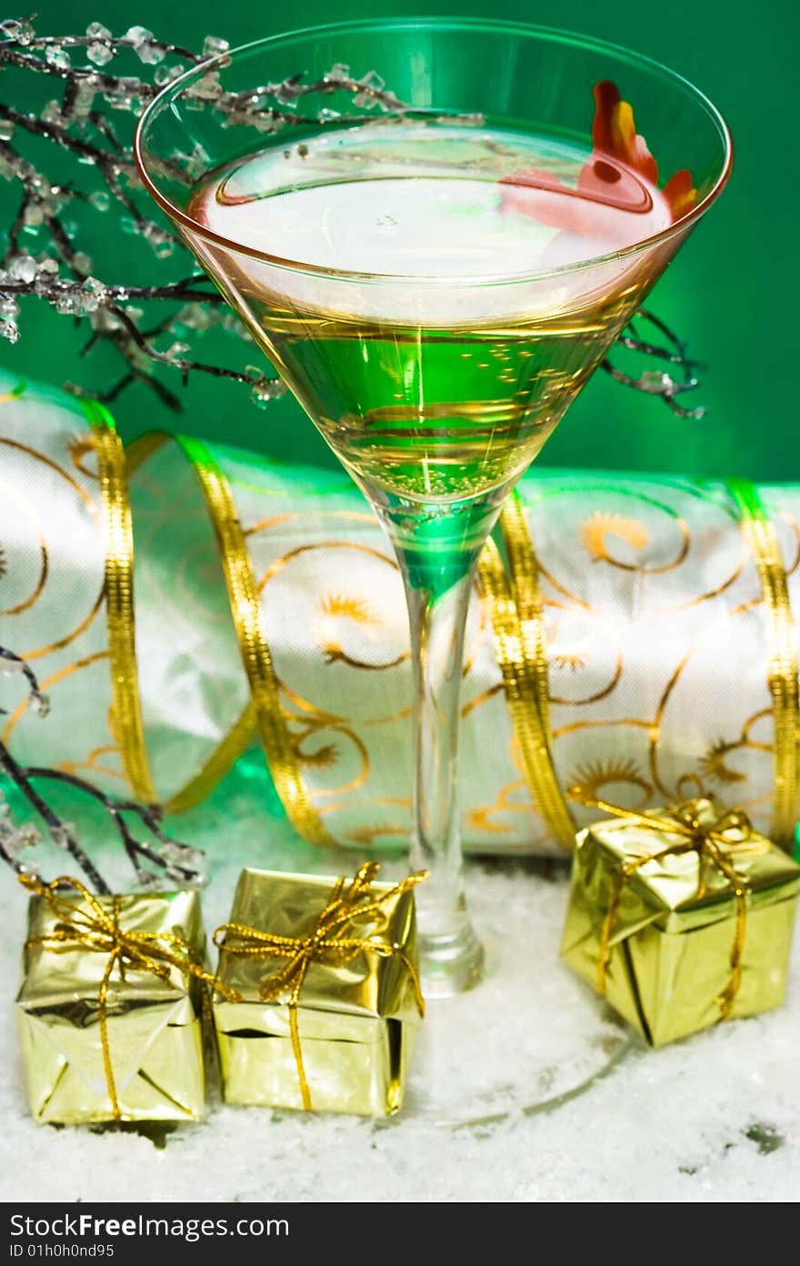 Glass with champagne and gift boxes