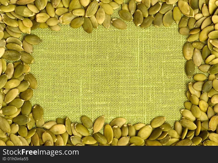 Macro pumpkin seeds frame over flax. Macro pumpkin seeds frame over flax