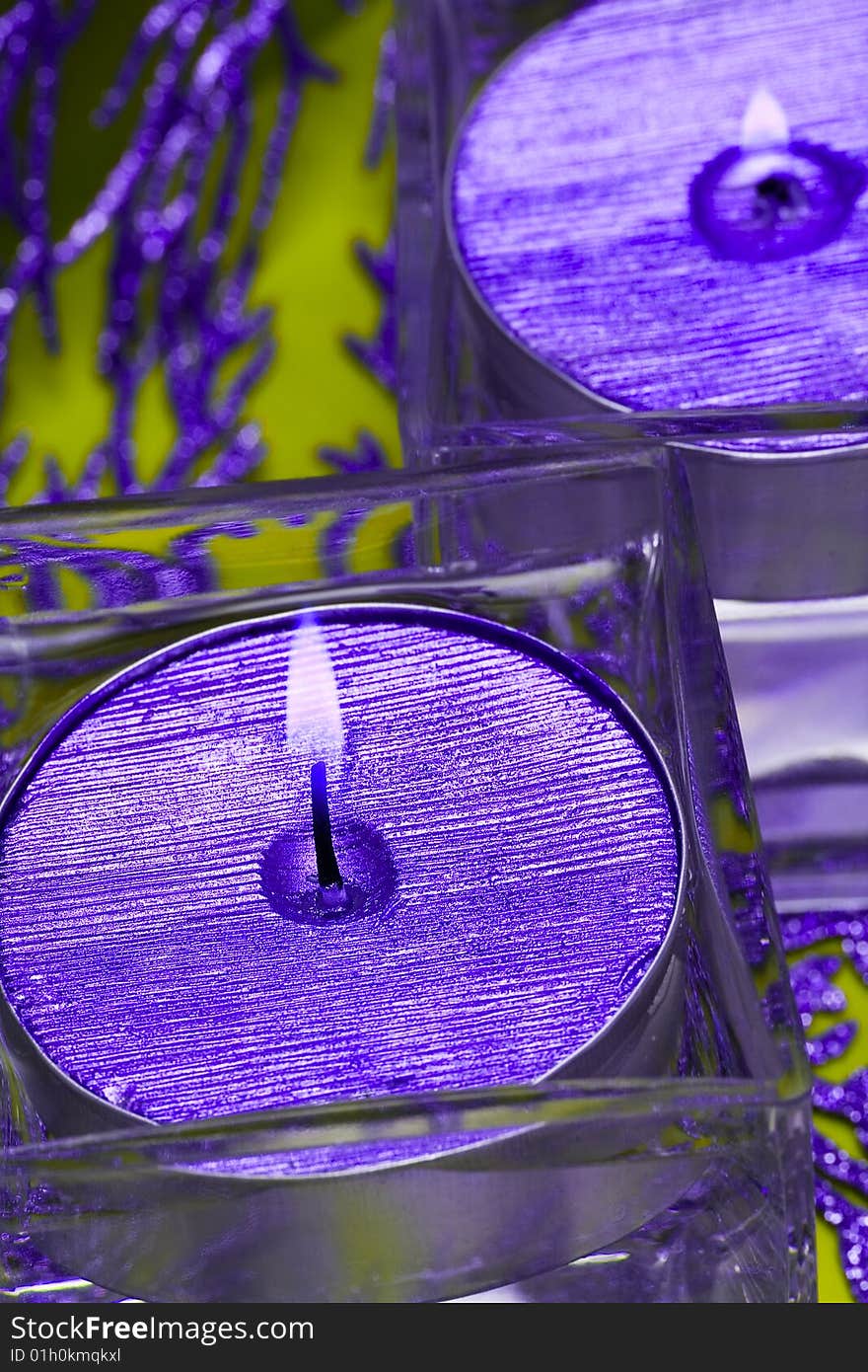 Violet candles in glass