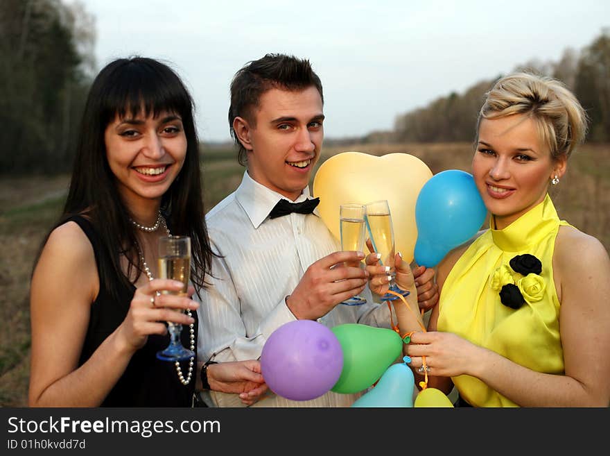 Two girl and man with wine outdoors. Two girl and man with wine outdoors