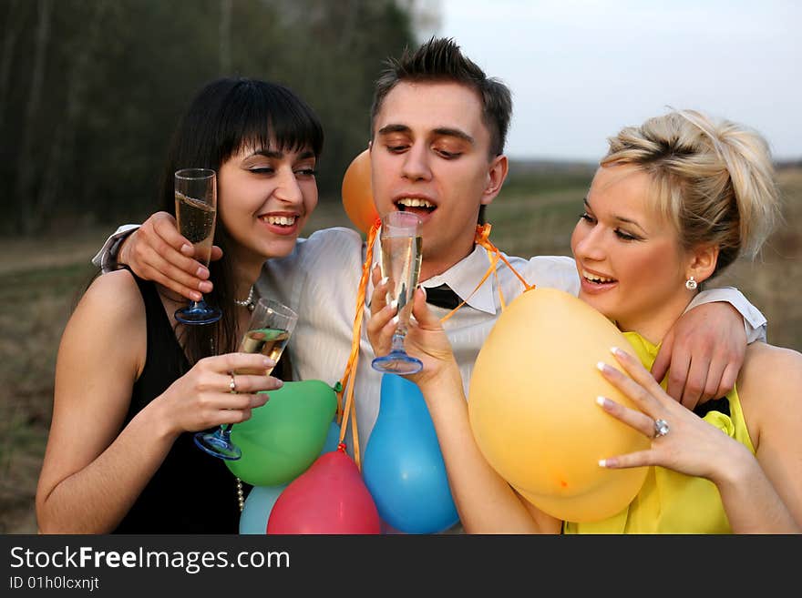 Two girl and man with wine outdoors. Two girl and man with wine outdoors