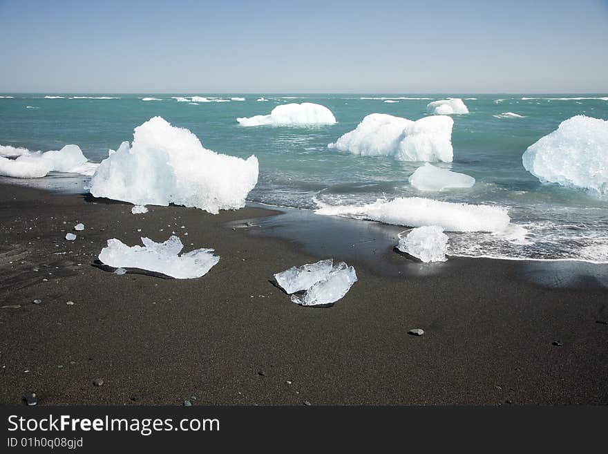 Ice from Jokullsarlon pushing into the sea and washed onto the beach. Ice from Jokullsarlon pushing into the sea and washed onto the beach.