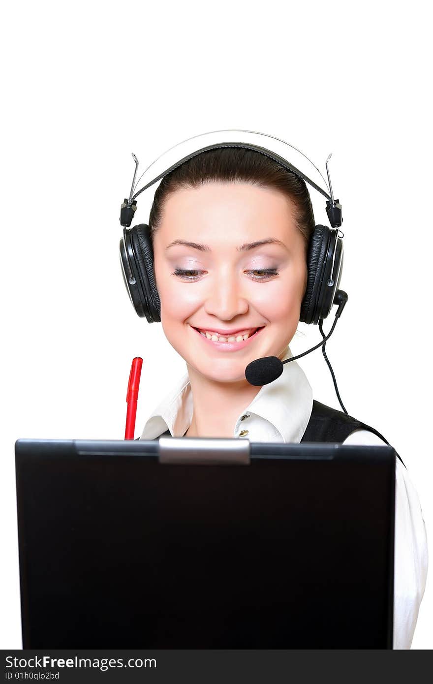 Portrait of the smiling receptionist in headset before a laptop. Portrait of the smiling receptionist in headset before a laptop