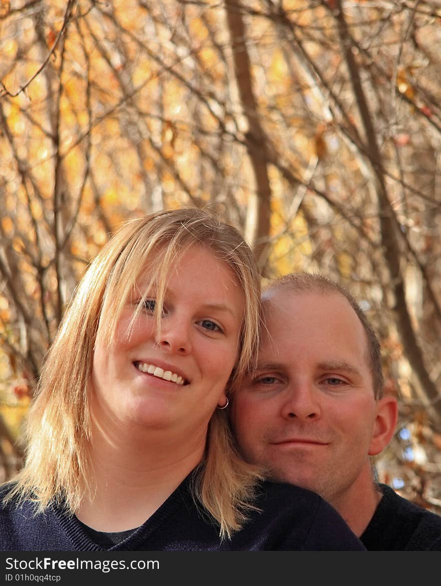 A happy young couple in the woods in Autumn